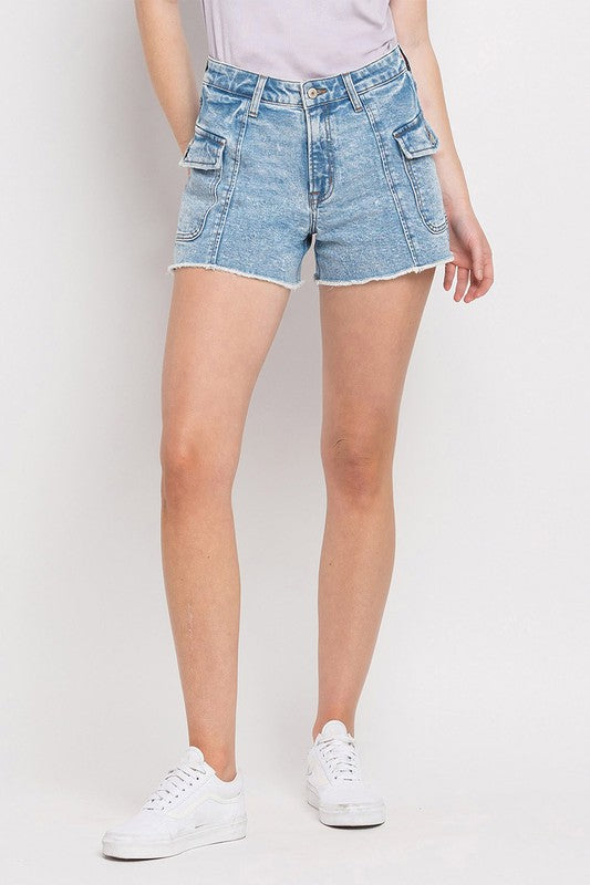 A gal in a soft white tee, relaxed Bella Blue Denim BF Cargo Shorts with frayed hems, and white kicks. Elle Boutique, Zachary, LA.