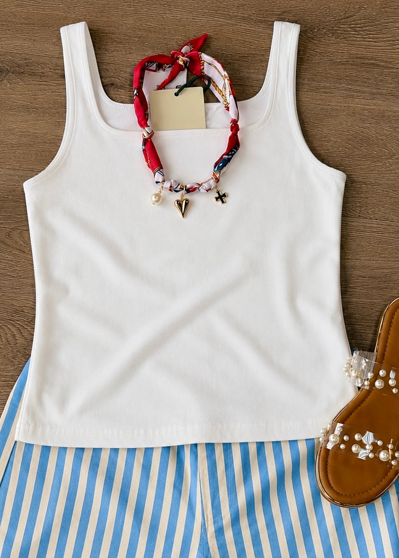 Soft cotton Simply Southern white tank with a relaxed fit, striped shorts, pearl-detailed sandals, charm necklace. Elle Boutique, Zachary, LA.