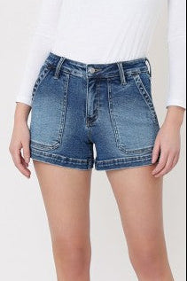 High-rise Pretty Pocket Denim Shorts in comfy stretch denim with a white fitted long-sleeve top. Elle Boutique, Zachary, LA.