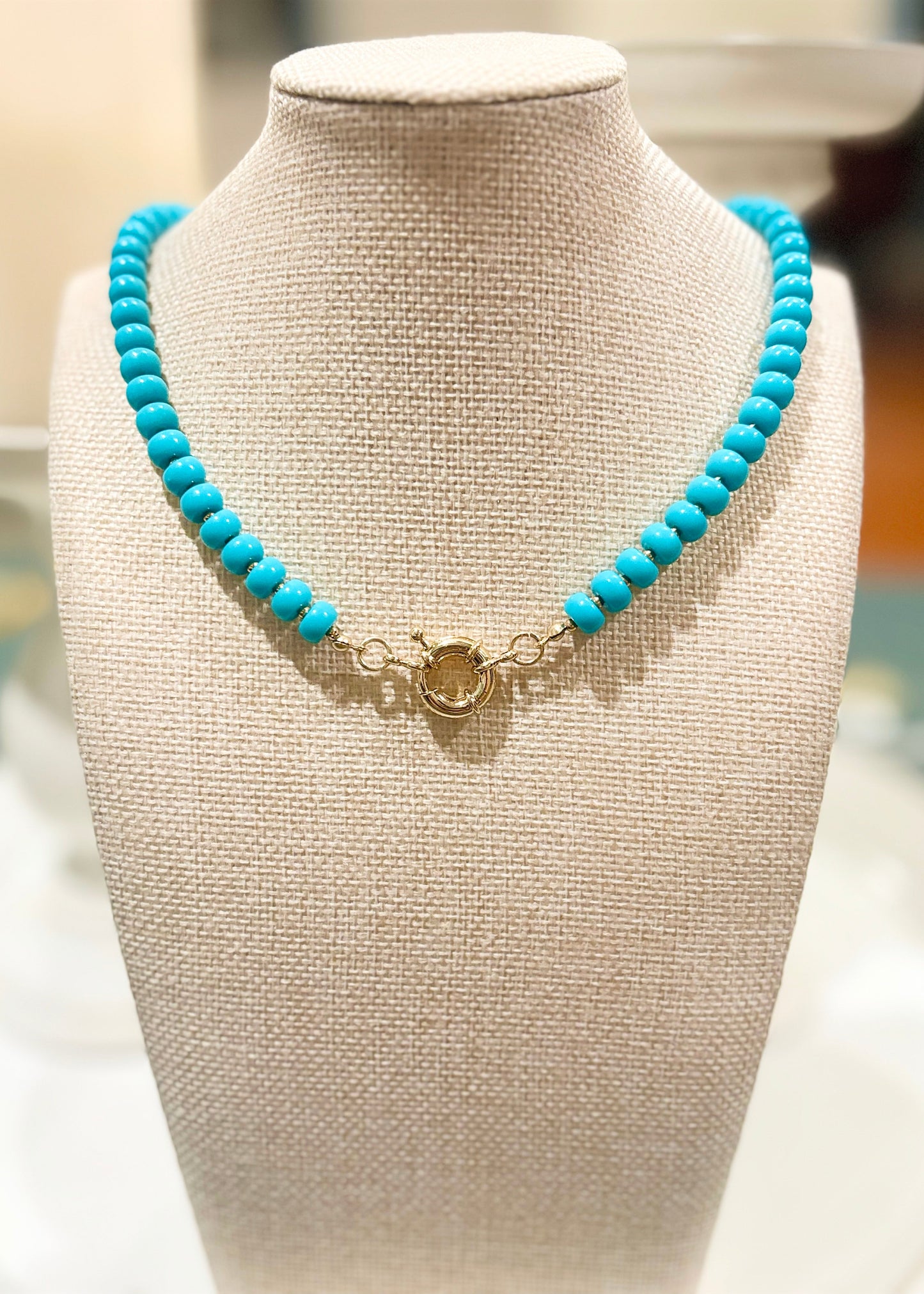 Round turquoise beads and a dainty gold clasp bring breezy charm to this necklace, styled at Elle Boutique, Zachary, LA.