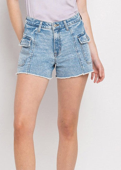 A gal in a soft white tee, relaxed Bella Blue Denim BF Cargo Shorts with frayed hems, and white kicks. Elle Boutique, Zachary, LA.