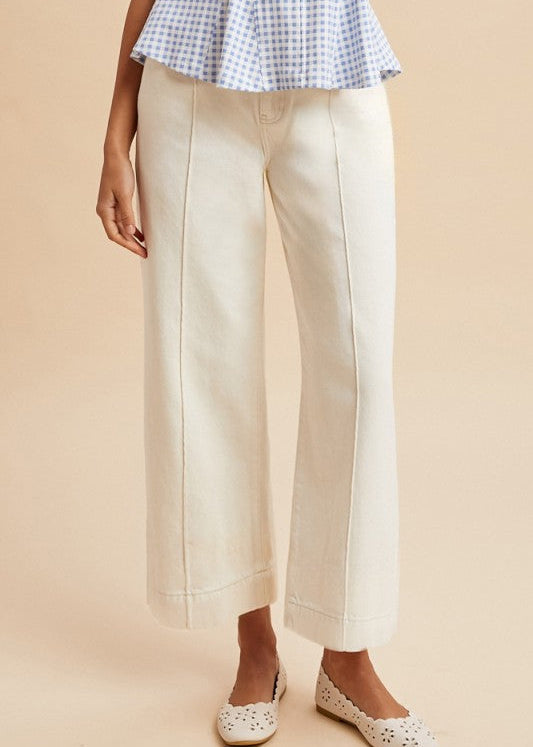 Soft cotton The Perfect Line white wide leg jeans with bold seams, blue gingham top, white cutout flats. Elle Boutique, Zachary, LA.