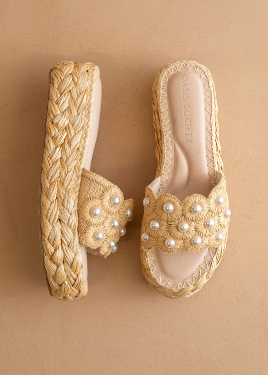 Step into Southern charm with braided raffia platforms, pearl-detailed wide straps, and sweet embroidery. Elle Boutique, Zachary, LA.