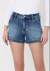 High-rise Pretty Pocket Denim Shorts in comfy stretch denim with a white fitted long-sleeve top. Elle Boutique, Zachary, LA.