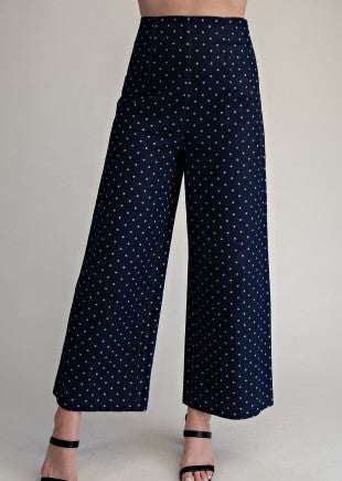 Step into Southern charm with our soft cotton Spot On Wide Leg Denim Jeans in a rich navy blue, featuring a flattering high-waisted fit and playful white polka dots all over. The easy, wide-leg silhouette brings comfort and style together, paired here with cute black strappy sandals for that effortless everyday look. Shown from waist to ankles for the perfect peek at the chic details. Elle Boutique, Zachary, LA.