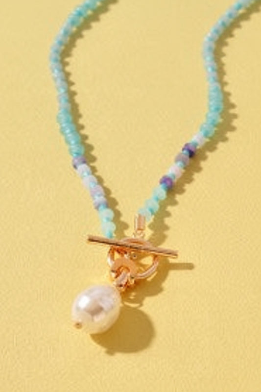 Sweet Southern charm shines in this turquoise-blue beaded necklace with gold toggle and pearl drop. Elle Boutique, Zachary, LA.