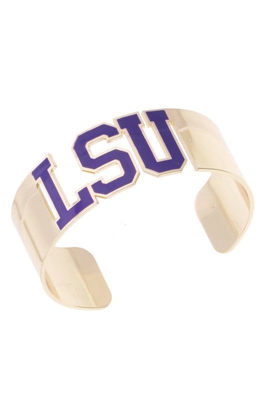 Cheer on the Tigers with this charming LSU cuff bracelet, crafted from shiny gold metal and adorned with bright purple LSU lettering for that true Southern flair. Its easy-to-wear open design makes it a comfy fit for any wrist, letting you show off your school pride all day long—whether you’re tailgating or heading to brunch. Perfect for layering or wearing solo, this game day favorite adds just the right touch of collegiate spirit to your outfit. Elle Boutique, Zachary, LA.