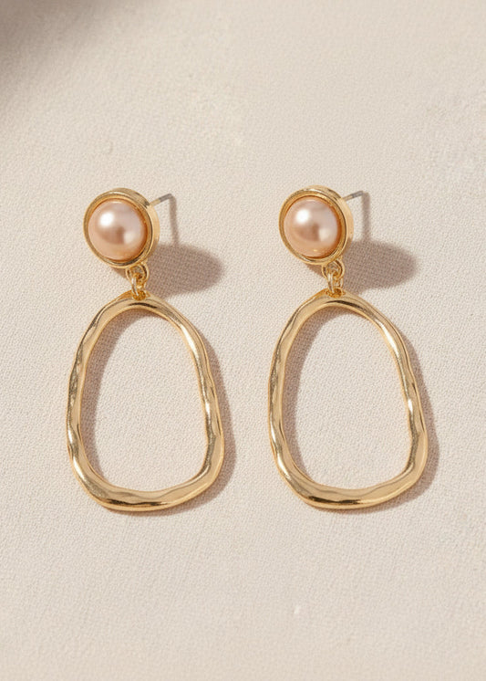 Gold-tone oval hoops pair with pearly studs for sweet Southern charm. Lightweight fit, perfect shine. Elle Boutique, Zachary, LA.