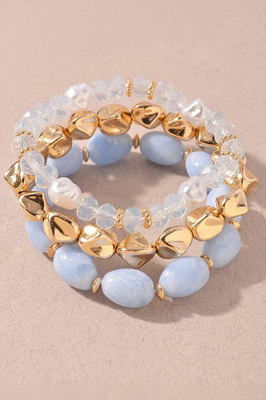 Sweet Southern charm shines in this stretchy Blue Lagoon bracelet stack with pretty blue stones, clear beads, and gold touches. Elle Boutique, Zachary, LA.