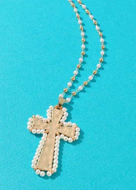 Charming gold cross pendant framed in dainty pearls, with a gold and pearl beaded chain. Elle Boutique, Zachary, LA.