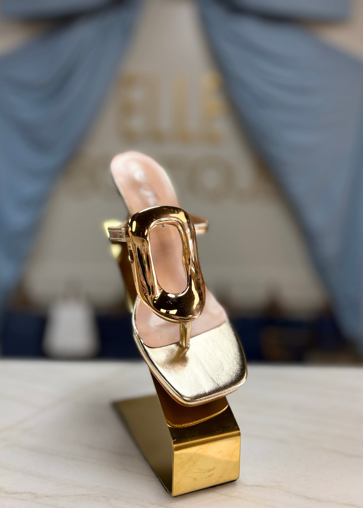 Step into a golden glow with these shimmery metallic heels, chic hardware accents, and comfy fit. Elle Boutique, Zachary, LA.