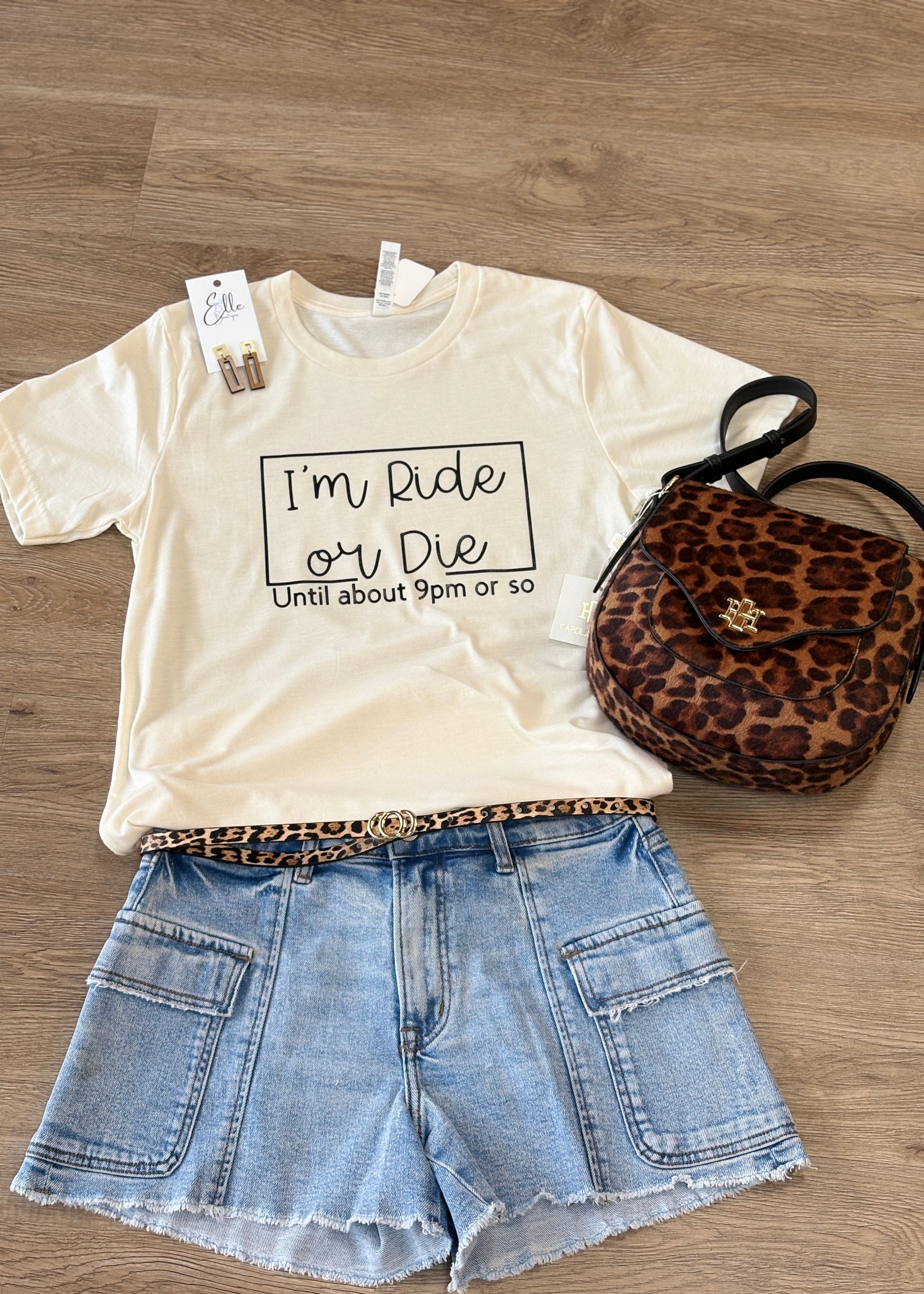 Cozy beige cotton Ride or Die tee with relaxed fit, denim shorts, leopard print belt & purse, gold earrings. Elle Boutique, Zachary, LA.