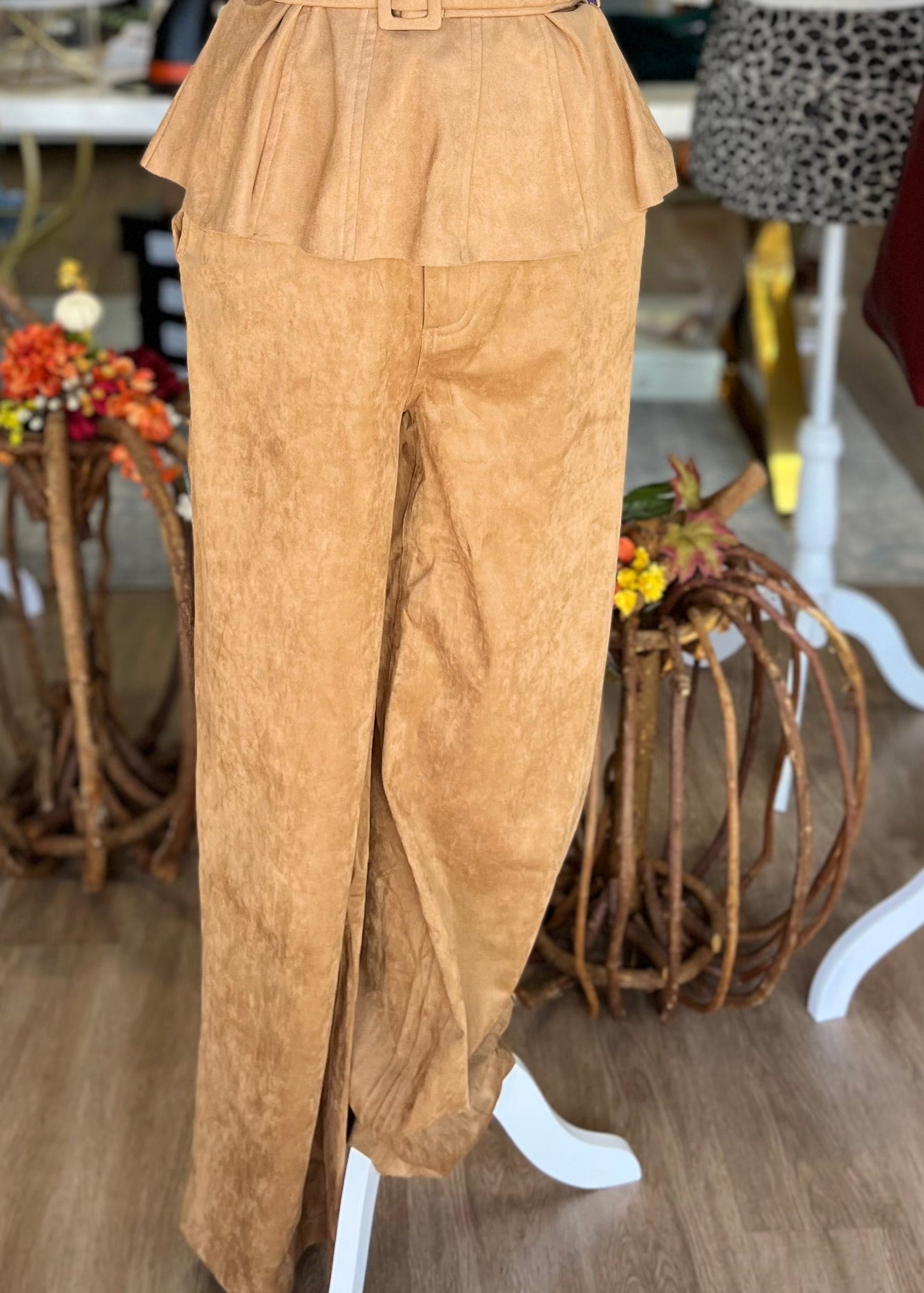The Harlow Pants in soft tan feature a high waist, comfy fit, and ruffled peplum waistband. Elle Boutique, Zachary, LA.