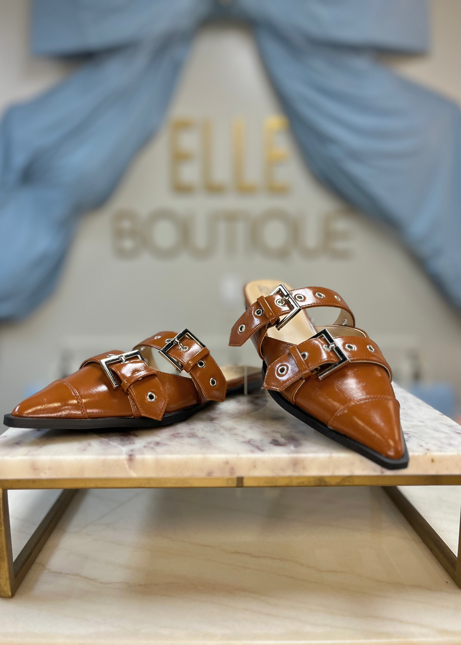 Slip into these camel faux leather flats with chic silver buckles and a pointed toe. Elle Boutique, Zachary, LA.