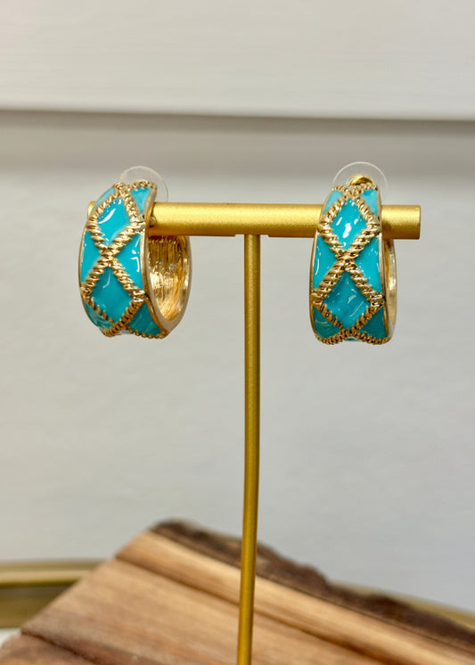 Add a pop of darling charm with gold hoops, turquoise enamel, and sweet crisscross detail. Elle Boutique, Zachary, LA.