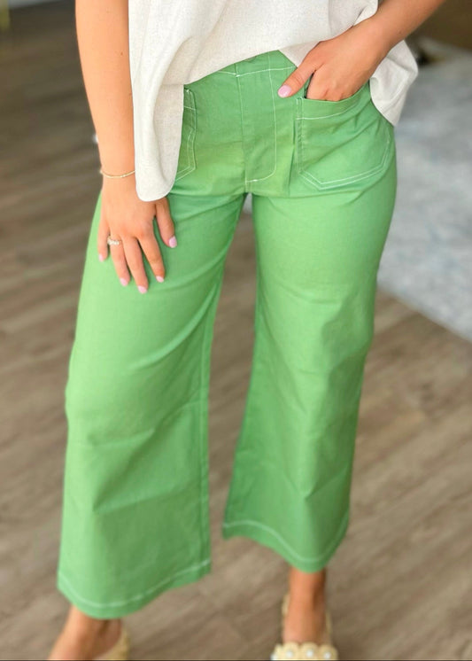 Chic apple green wide leg pants, soft fabric, relaxed fit, roomy pockets; styled with a light blouse. Elle Boutique, Zachary, LA.