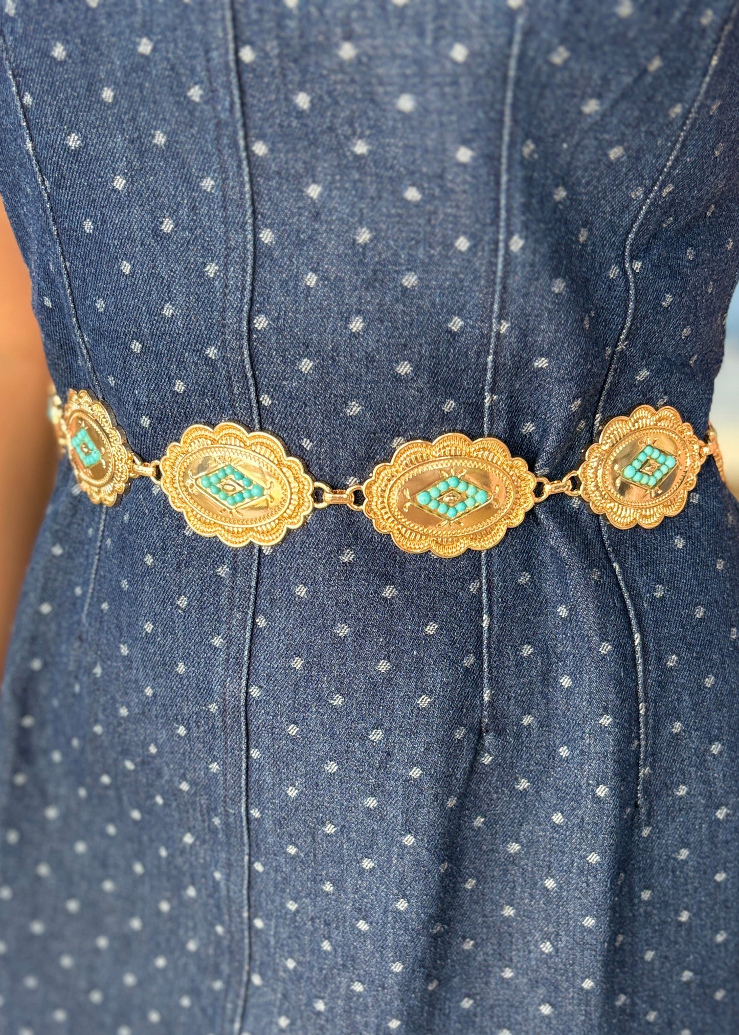 A sweet blue patterned dress paired with our turquoise and gold concho belt for a charming cowgirl flair. Elle Boutique, Zachary, LA.