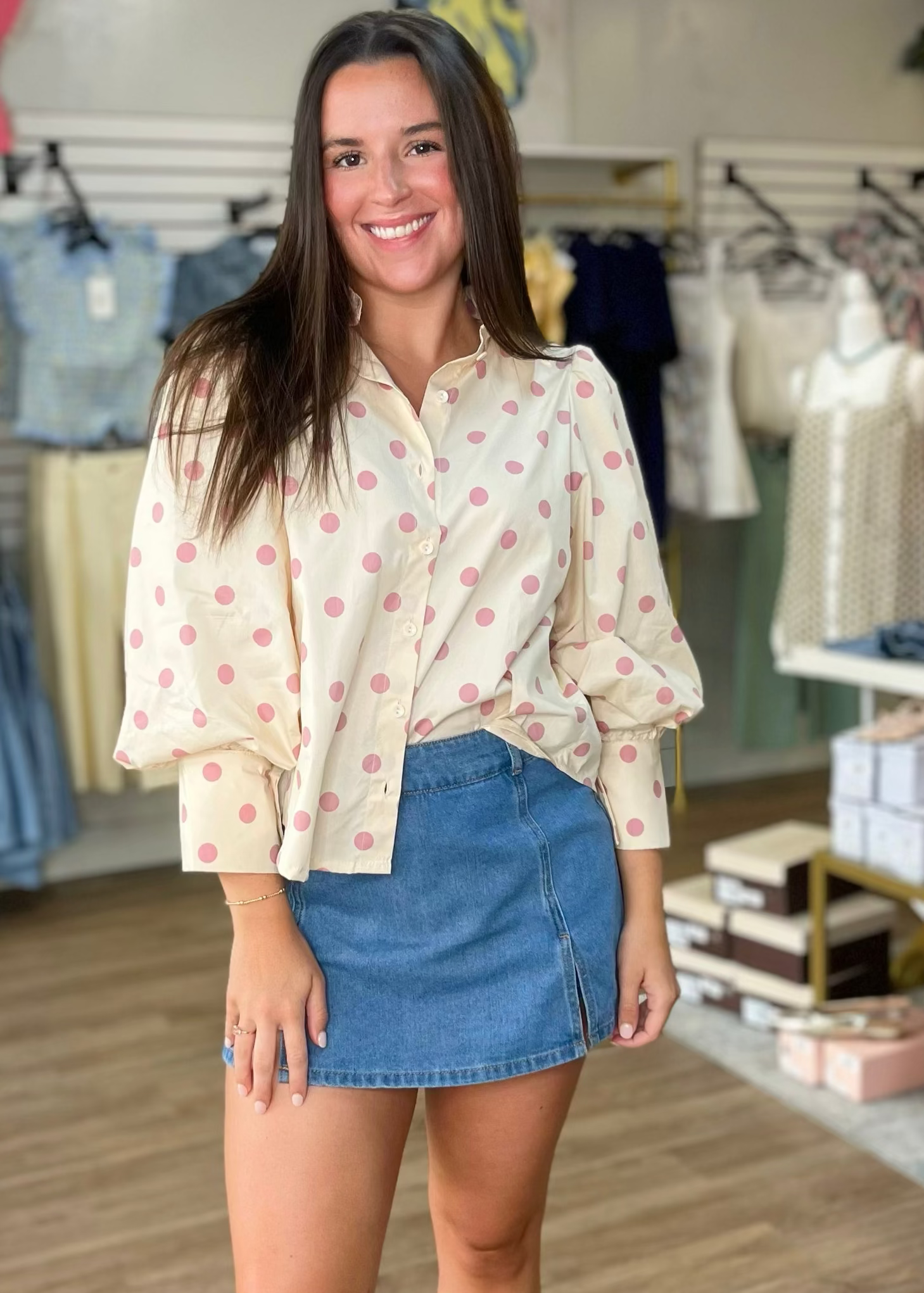 A sweet gal models a soft denim skort with a comfy fit and a beige, pink-spotted blouse. Elle Boutique, Zachary, LA.
