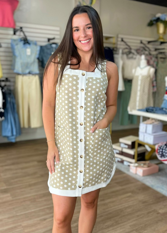 A woman beams in our Sweet Tea Polka Dot Denim Dress—sleeveless, soft beige cotton, white trim—at Elle Boutique, Zachary, LA.