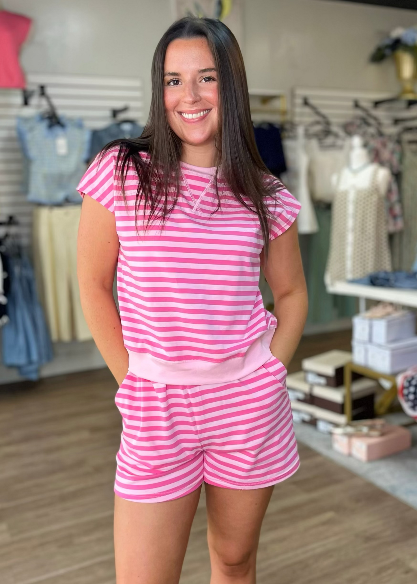 A cheerful woman with brown hair wears our soft, pastel Pink Lemonade Lounge Set—a cozy, flattering fit—at Elle Boutique, Zachary, LA.