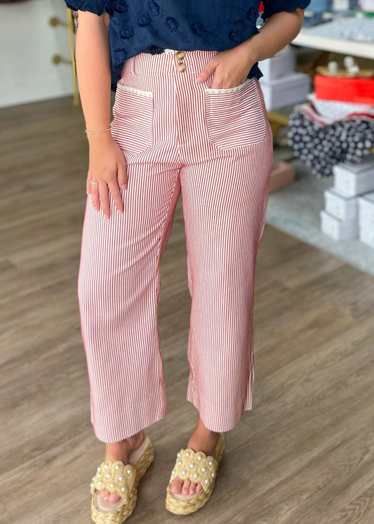 A gal in pink & white cotton wide-leg, high-rise pants with a navy top and pearl-detailed sandals at Elle Boutique, Zachary, LA.