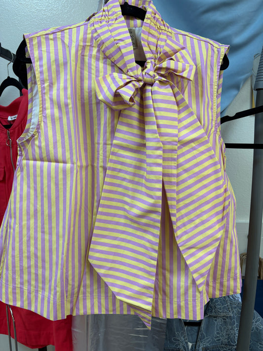 The Tiger Tail Bow Blouse brings a playful pop of color with its vertical lavender and golden yellow stripes, all gathered together by a charming oversized bow at the collar. Crafted from soft, breathable fabric, this sleeveless top offers a breezy fit perfect for cheering on LSU or enjoying sunny Southern days. Shown on a black hanger alongside fellow boutique finds. Elle Boutique, Zachary, LA.