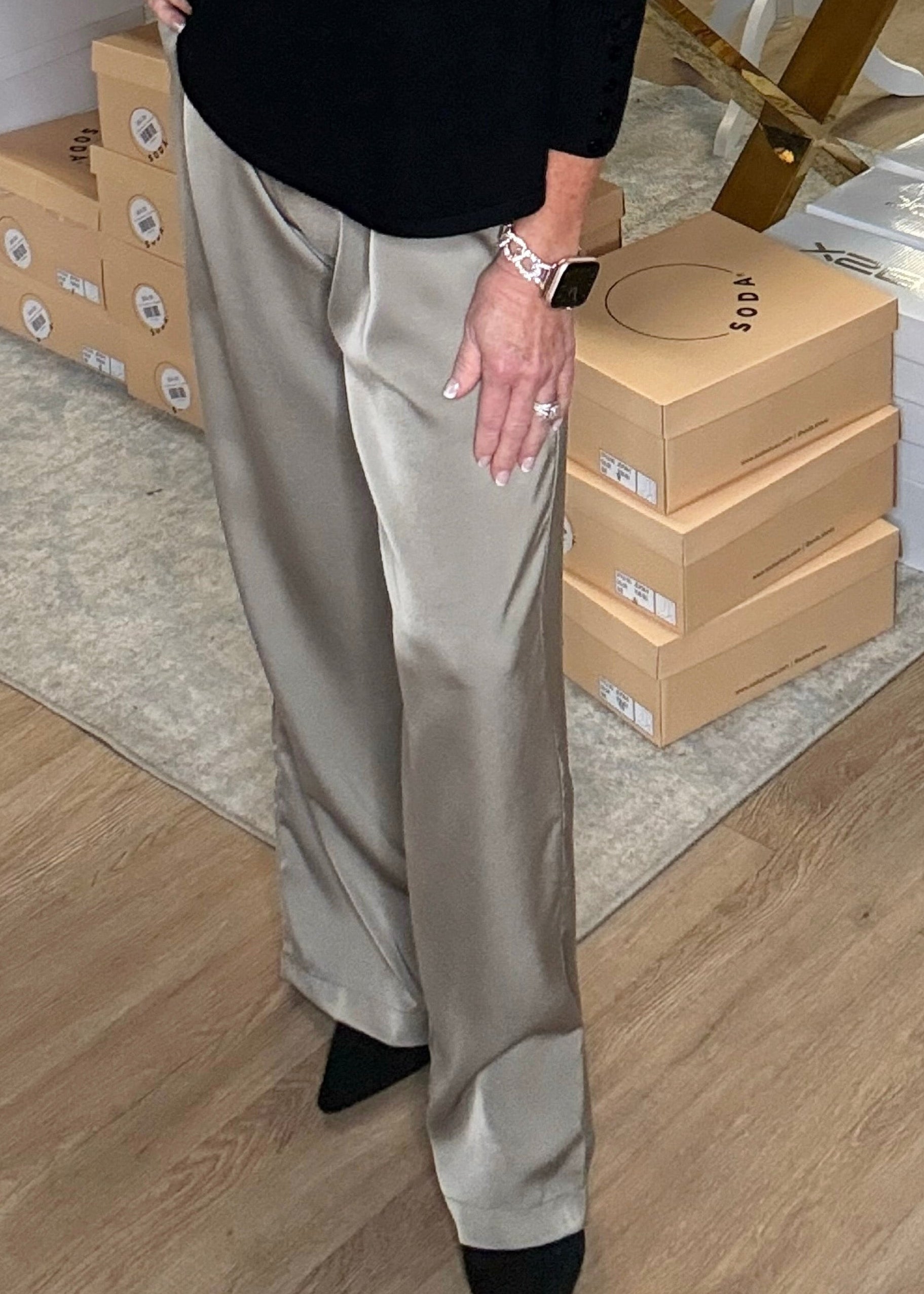 Soft mocha Eloise satin pants, black tee, comfy black shoes, silver bracelet & smartwatch—at Elle Boutique, Zachary, LA.