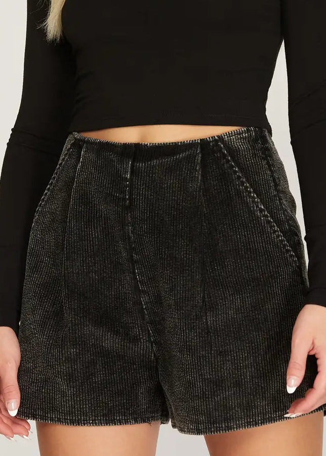 High-rise dark gray corduroy shorts with a soft feel, paired with a black crop top. Relaxed and cute. Elle Boutique, Zachary, LA.