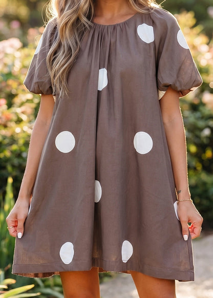 Soak up summer in this breezy cotton-blend brown polka dot mini dress with puff sleeves and knot-back. Elle Boutique, Zachary, LA.